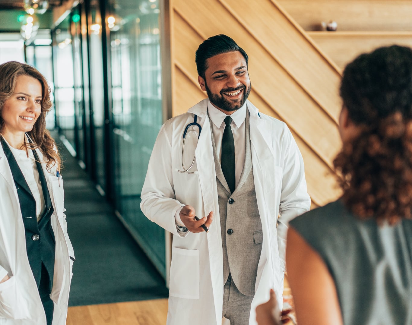 Two clinicians talking to someone else