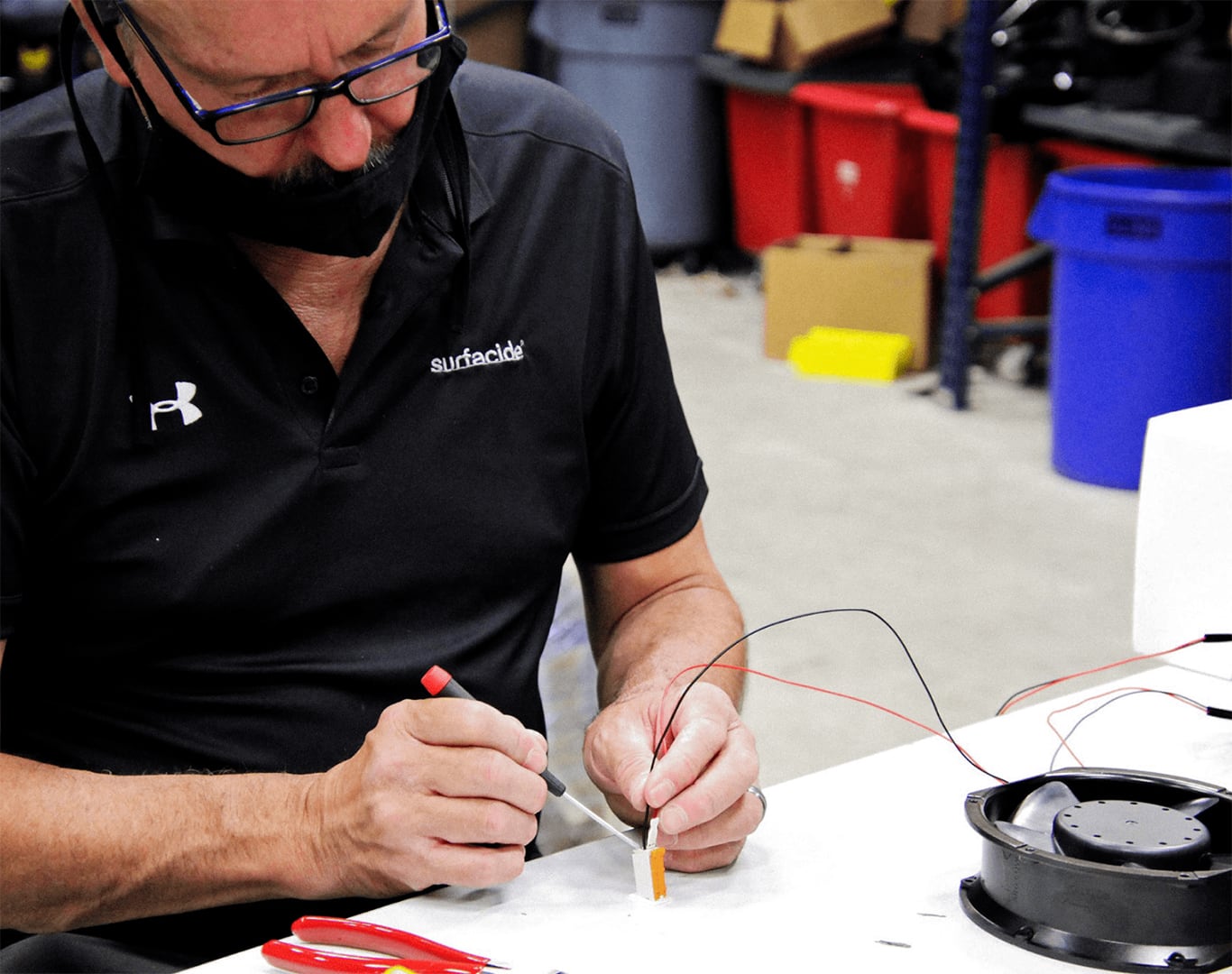 Someone working on wires that connect to a disinfection system