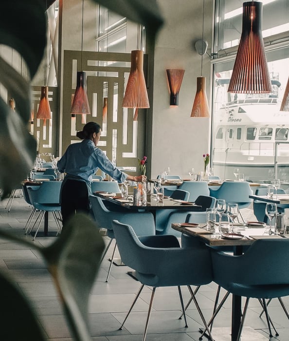 A restaurant worker fixing a table