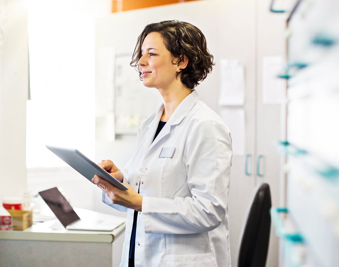 A clinician holding a tablet